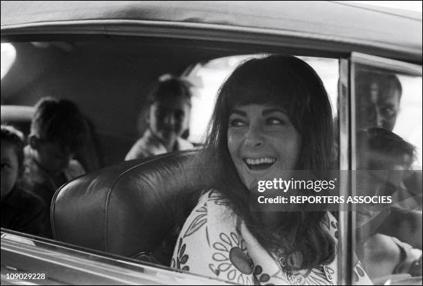 Liz Taylor and Richard Burton with their children while on vacation on the French Riviera in 1965.