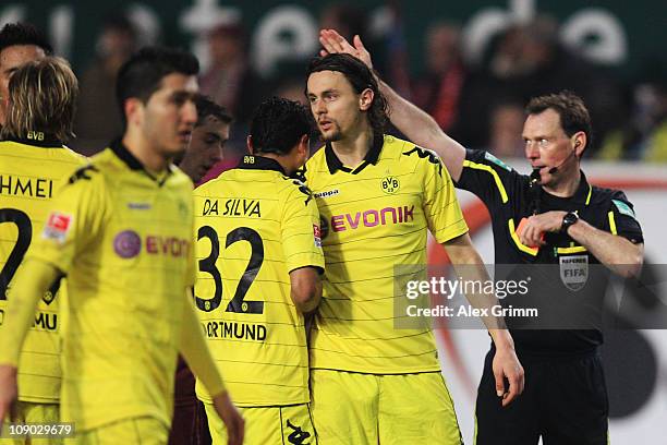 Neven Subotic of Dortmund is sent off by referee Florian Meyer during the Bundesliga match between 1. FC Kaiserslautern and Borussia Dortmund at...