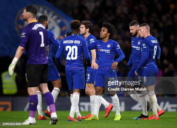 Willian of Chelsea celebrates after scoring his team's third goal with his team mates as Keiren Westwood of Sheffield Wednesday looks dejected during...