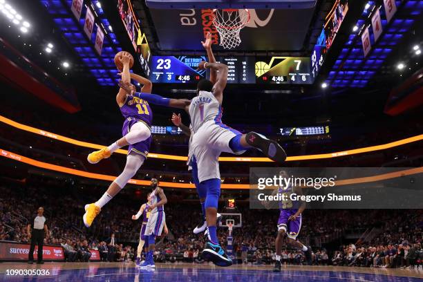 Dante Exum of the Utah Jazz takes a first half shot over Reggie Jackson of the Detroit Pistons during the first half at Little Caesars Arena on...