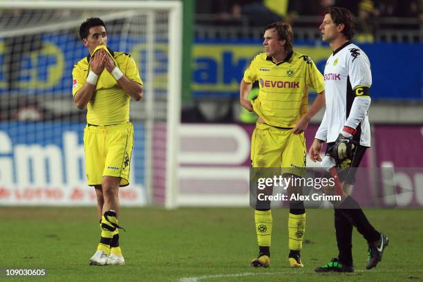 Lucas Barrios, Kevin Grosskreutz and goalkeeper Roman Weidenfeller of Dortmund react after the Bundesliga match between 1. FC Kaiserslautern and...