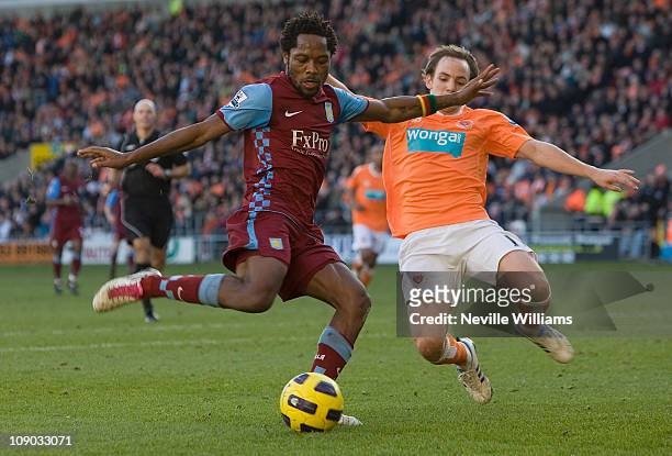 Jean II Makoun of Aston Villa is challenged by David Vaughan of Blackpool during the Barclays Premier League match between Blackpool and Aston Villa...