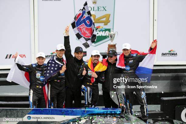 The Konica Minolta Cadillac DPi-V.R. Cadillac DPi team of Renger Van Der Zande, Jordan Taylor, Fernando Alonso, and Kamui Kobayashi celebrate after...