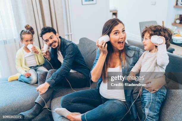 family having fun with string phones - ball of string stock pictures, royalty-free photos & images