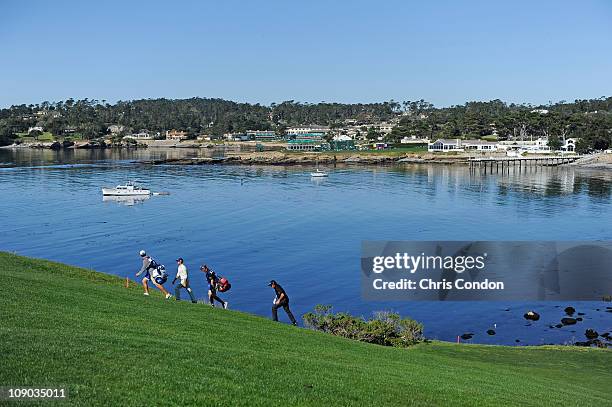 Phil Mickelson and Jonathan Byrd walk up the hill at the 6th fairway during the third round of the AT&T Pebble Beach National Pro-Am at Pebble Beach...