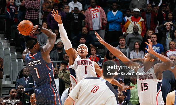 Stephen Jackson of the Charlotte Bobcats shoots the game-winning jumper as time expires over Maurice Evans and Al Horford of the Atlanta Hawks at...