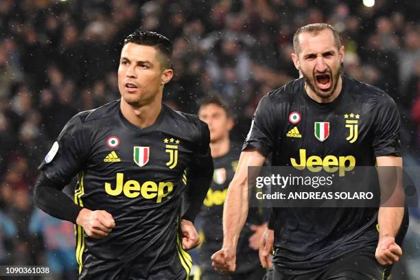 Juventus' Portuguese forward Cristiano Ronaldo and Juventus' Italian defender Giorgio Chiellini celebrate after Ronaldo scored a penalty during the...