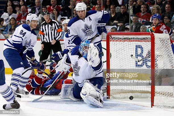 Jean-Sebastien Giguere of the Toronto Maple Leafs lets in a goal on a shot by Benoit Pouliot of the Montreal Canadiens during the NHL game at the...