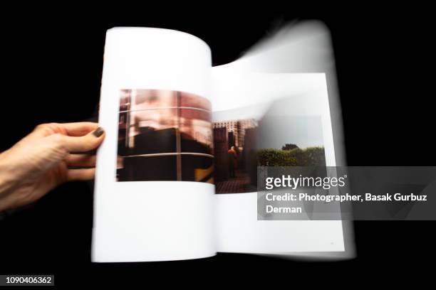 looking through magazine, turning pages - hand turning page stock pictures, royalty-free photos & images