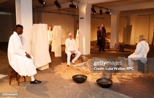 Models pose at the Omar Afridi presentation at the DiscoveryLAB during London Fashion Week Men's January 2019 at the BFC Designer Showrooms on...