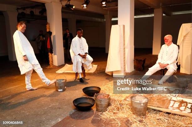 Models pose at the Omar Afridi presentation at the DiscoveryLAB during London Fashion Week Men's January 2019 at the BFC Designer Showrooms on...