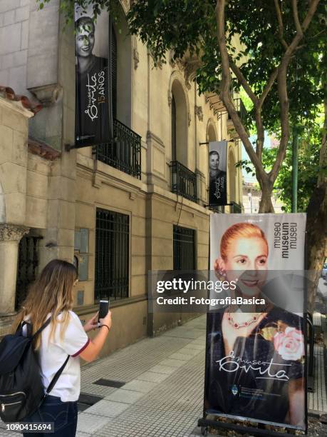 tourist taking picture of eva perón banner - evita museum stock pictures, royalty-free photos & images