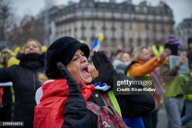 Female Gilets Jaunes or Yellow Vest protestor screams during demonstrations at Place de la Bastille as part of the Women only 'Gilets Jaunes' or...