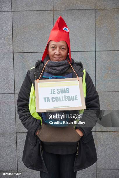 Female Gilets Jaunes or Yellow Vest protestor poses with a sign that reads 'I am your colleague' to signify that everybody is united, during the...