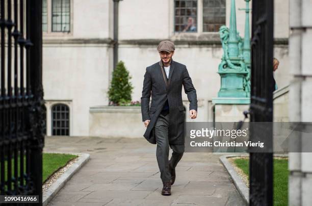 David Beckham is seen outside Kent & Curwen wearing flat cap, wool coat during London Fashion Week Men's January 2019 on January 06, 2019 in London,...