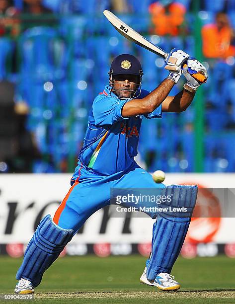 Dhoni of India hits the ball towards the boundary during the 2011 ICC World Cup Warm up game between India and Australia at the M. Chinnaswamy...