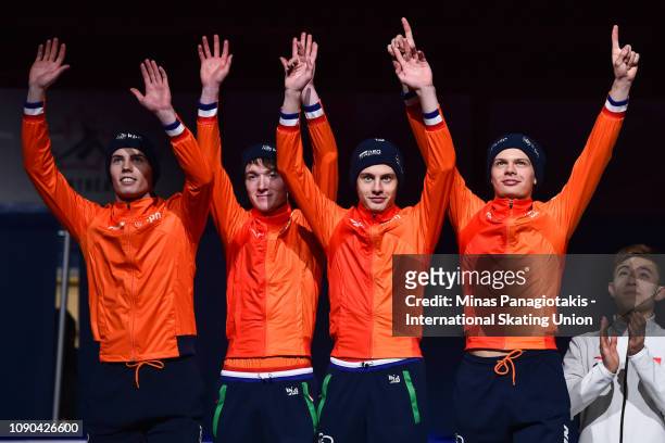 Team Netherlands react as they step onto the podium to receive their silver medals after finishing second in the men's 3000m relay final during the...