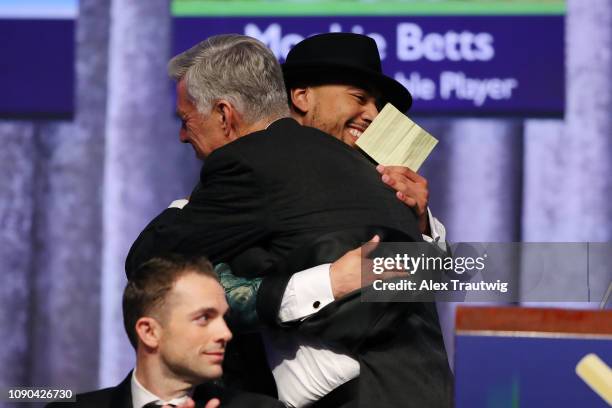 American League MVP Mookie Betts of the Boston Red Sox hugs President of Baseball Operations David Dombrowski during the 2019 Baseball Writers'...