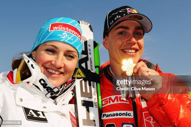 Elisabeth Goergl of Austria celebrates with Men's Downhill champion Erik Guay of Canada after winning the Women's Downhill during the Alpine FIS Ski...