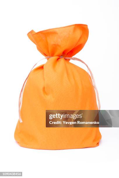 orange pouch bag with ribbon isolated on white background - påse bildbanksfoton och bilder