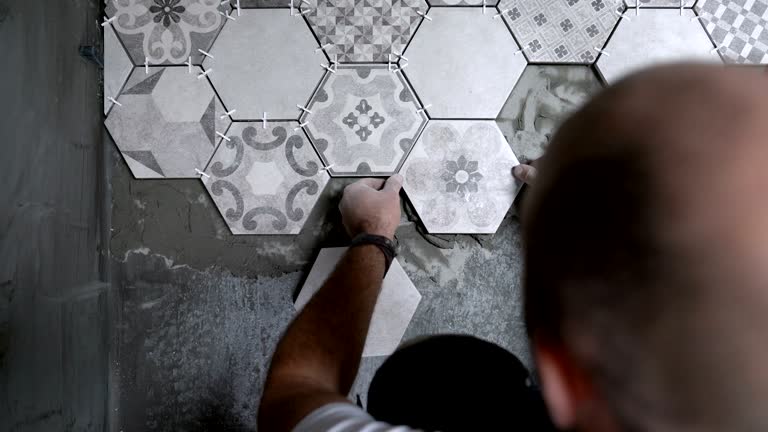 https://media.gettyimages.com/id/1090445796/video/builder-placing-tiles-on-the-floor.jpg?b=1&s=640x640&k=20&c=RigVs16CDCD4DYjWJWUSBXaSO8CWRo4W7e8uBks66fU=