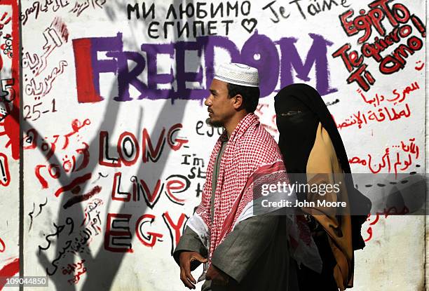 Egyptians walk past revolutionary graffiti on February 13, 2011 in Cairo, Egypt. Two days after the resignation of President Hosni Mubarak, the...