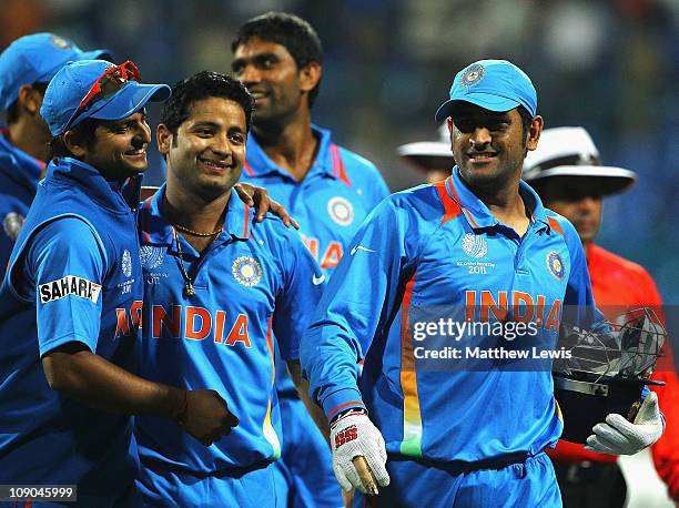 Dhoni, Captain of India walks off with Suresh Raina and Piyush Chawla after beating Australia during the 2011 ICC World Cup Warm up game between...