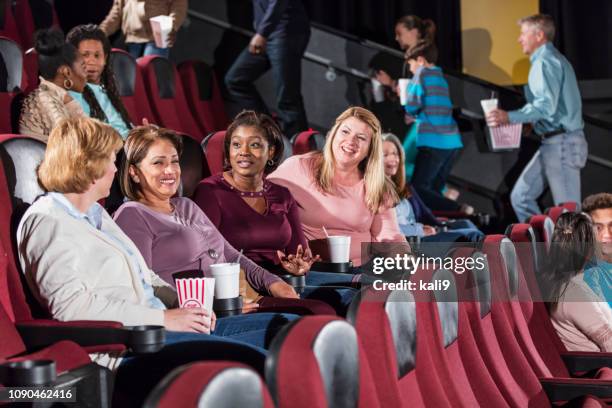 multi-ethnic group in a movie theater, getting seated - 50 watching video stock pictures, royalty-free photos & images