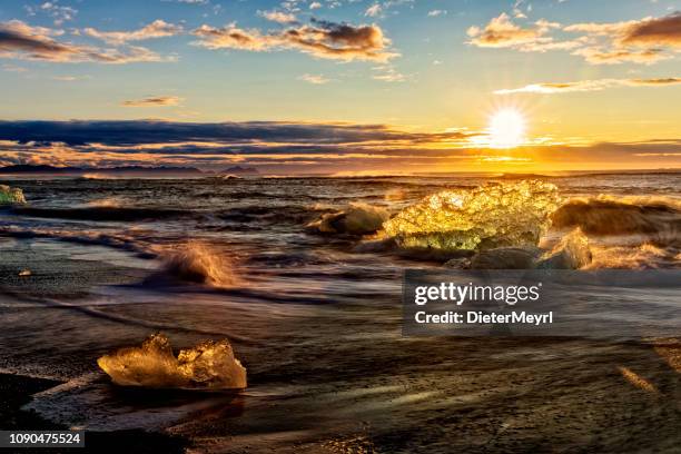 ice rock on the black sand at diamond beach, iceland - reykjavik winter stock pictures, royalty-free photos & images