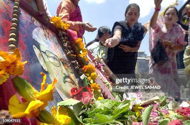 Nepalese women light insences while they pray for their beloved King Birendra and his family members, who were killed during the royal palace...