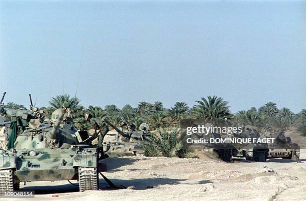 Soldier stands near the abandonned T-54 and T-55 tanks belonging to the Lybian army on April 9, 1987 at Faya-Largeau, after the defeat of Lybian army...