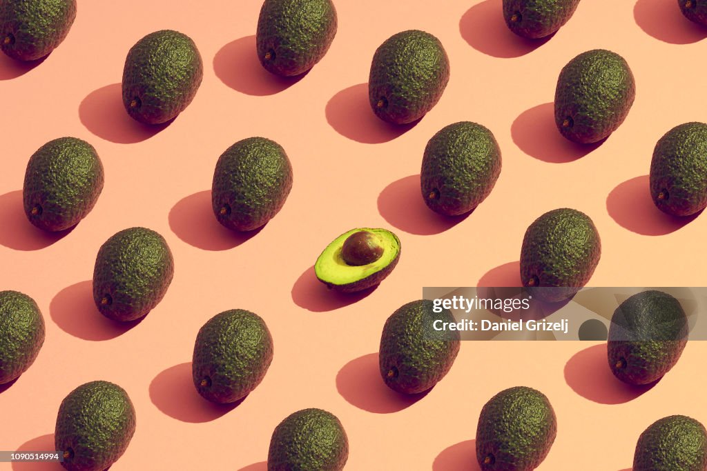 Large group of avocados placed in a pattern