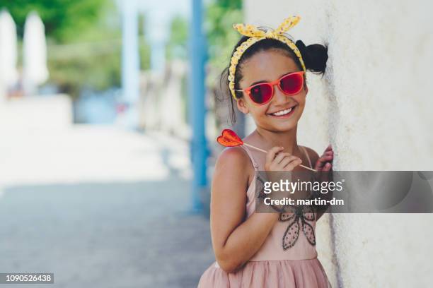 cute kid with heart-shaped lollipop - preteen girl models stock pictures, royalty-free photos & images
