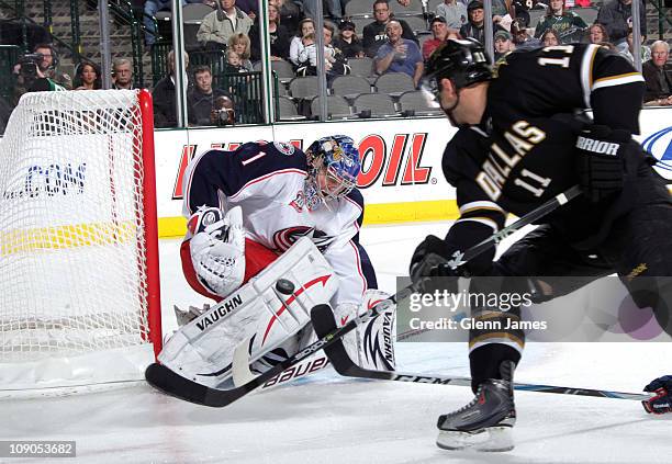 Steve Mason of the Columbus Blue Jackets makes a save against Aaron Gagnon of the Dallas Stars at the American Airlines Center on February 13, 2011...