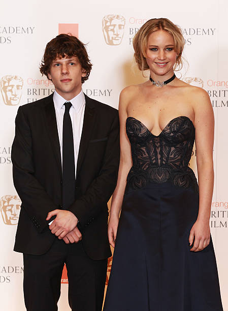 Jennifer Lawerance and Jesse Eisenberg pose in front of the winners boards during the Orange British Academy Film Awards at The Royal Opera House on...