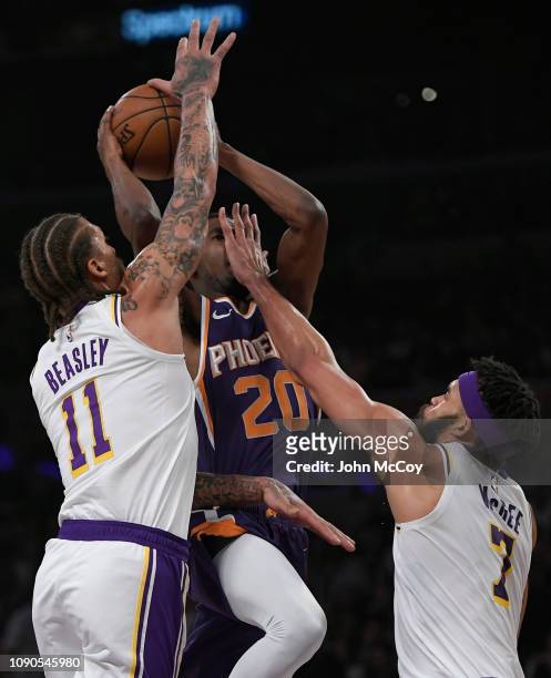 JaVale McGee fouls Josh Jackson of the Phoenix Suns as Michael Beasley of the Los Angeles Lakers blocks the shot in the first half at Staples Center...