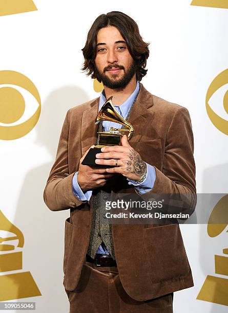 Songwriter Ryan Bingham, winner of the Best Song Written For Motion Picture, Television Or Other Visual Media award for "'The Weary Kind' " poses in...
