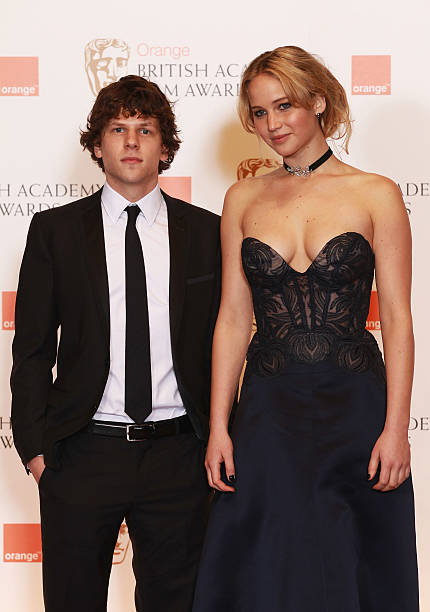 Jennifer Lawerance and Jesse Eisenberg pose in front of the winners boards during the Orange British Academy Film Awards at The Royal Opera House on...