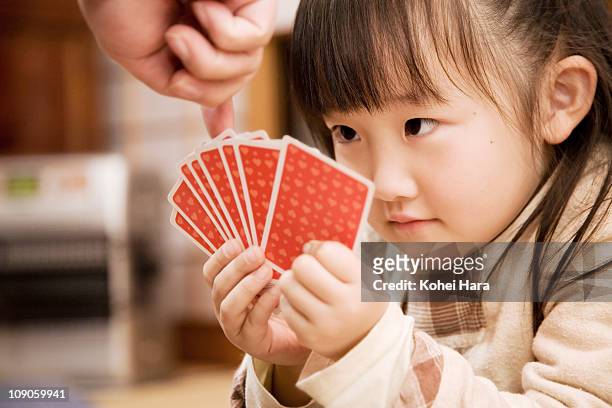 a girl playing cards - thinking of you card stock-fotos und bilder
