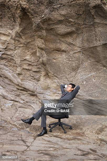 a businessman with laptop on a chair. - outdoor guy sitting on a rock stock pictures, royalty-free photos & images