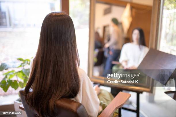 woman sitting in beauty salon - straight hair stock pictures, royalty-free photos & images