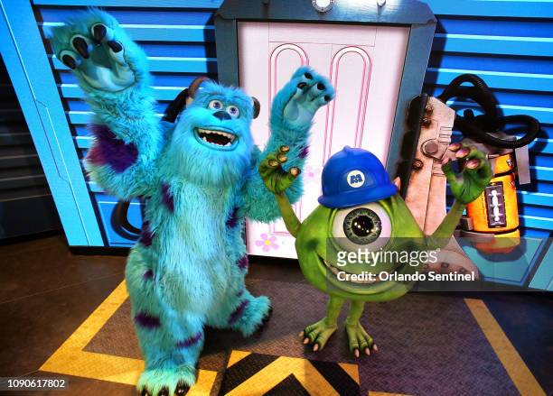 Pixar characters Mike Wazowski, right, and Sulley greet guests at the debut of "An Incredible Celebration" at Disney's Hollywood Studios at Walt...