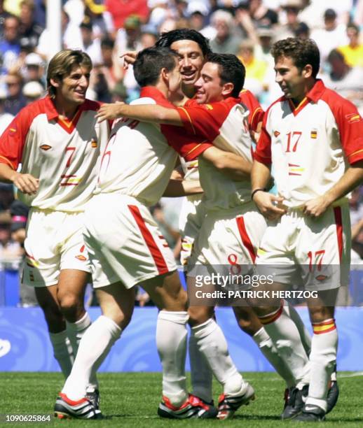 Spanish midfielder Xavi is congratulated by his teammates Angulo , Albelda and Tamudo after scoring the first goal 30 September 2000 at the Sydney...