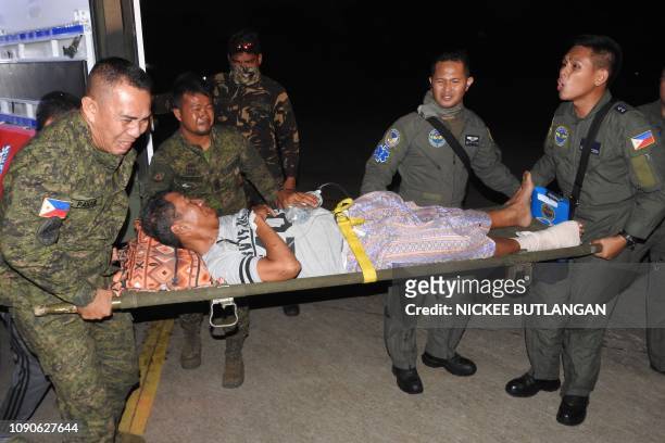 Wounded victim of the explosion inside the catholic cathedral is carried to a military plane in Jolo town, sulu province, in southern island of...