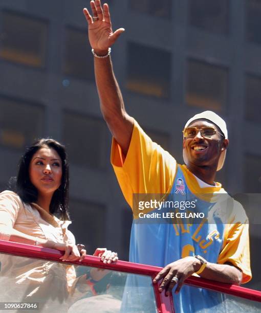 Los Angeles Lakers Kobe Bryant , with wife Vanessa Laine , waves to fans during a parade through downtown Los Angeles, CA celebrating the team's...