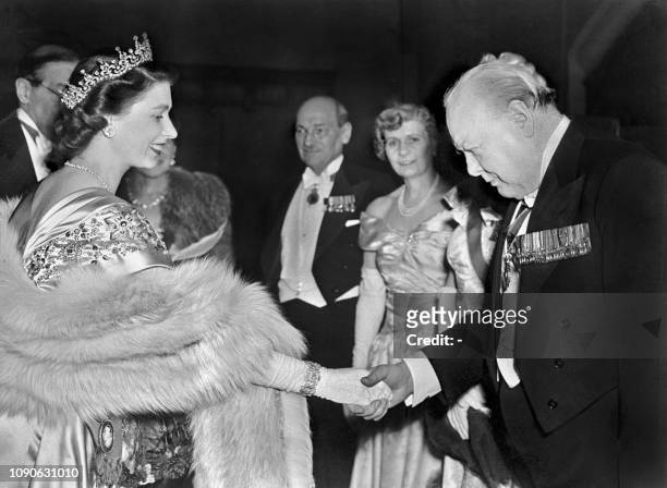 The Princess Elizabeth of Great Britain greets Winston Churchill at a Guildhall reception, 23 March 1950 in London. In the background can be seen the...