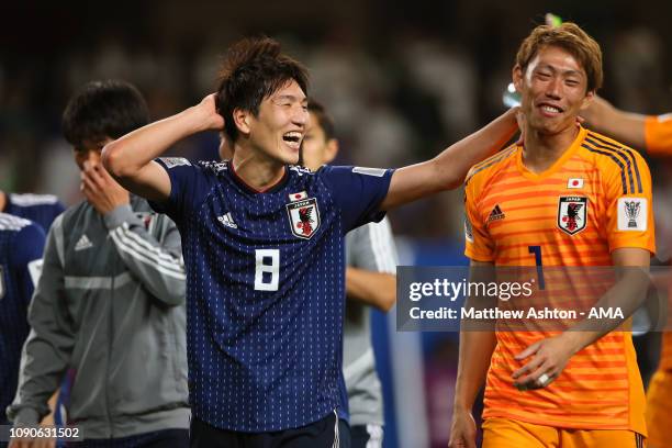 Genki Haraguchi of Japan celebrates with Masaaki Higashiguchi of Japan at the end of the AFC Asian Cup semi final match between Iran and Japan at...