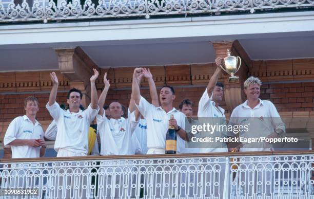 Lancashire captain Mike Watkinson celebrates with teammates on the pavilion balcony after winning the Benson and Hedges Cup Final between Lancashire...