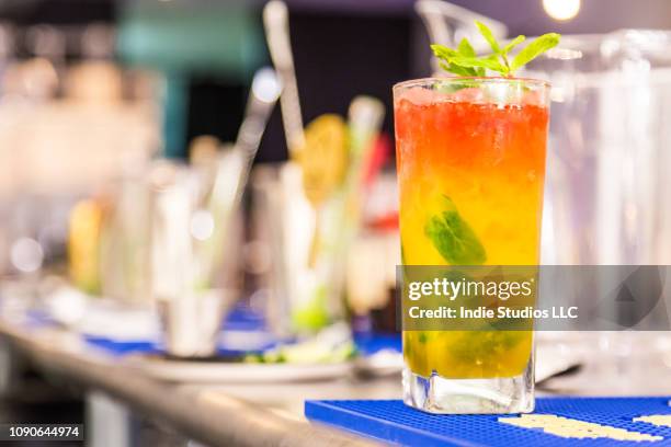 zebra crossing cocktail sits on a stainless steele table with bar utensils in the background - sour taste stock pictures, royalty-free photos & images