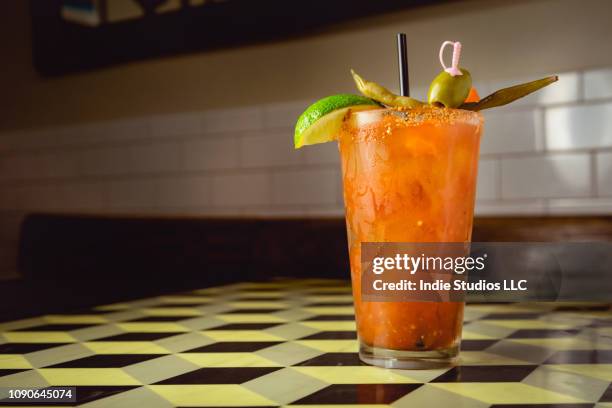 close up bloody mary cocktail sweating on a 3d checkerboard table - bloody mary stock pictures, royalty-free photos & images
